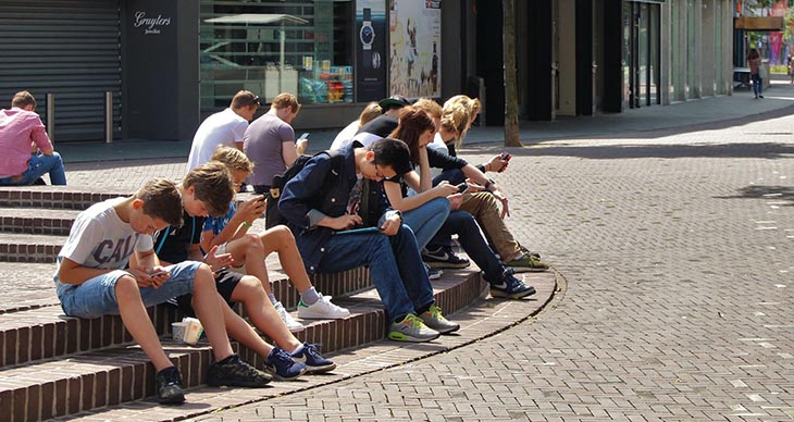 picture of a group of kids on digital devices to accompany article about Gaggle online student privacy